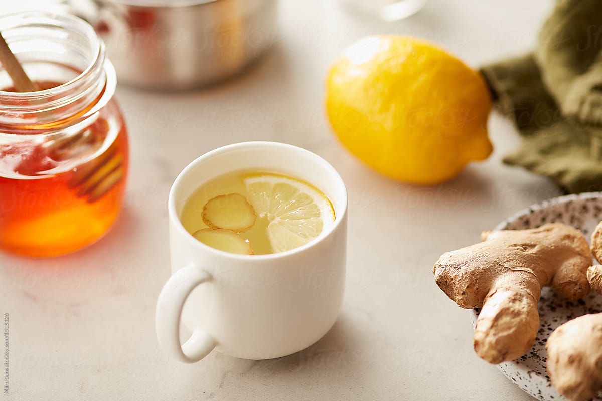 Cup of hot honey lemon tea with ginger root.