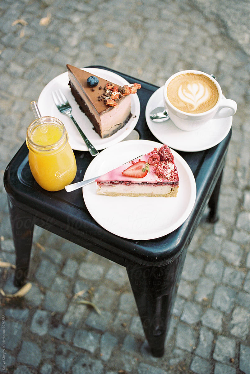 cakes, orange juice , and coffee at a cafe
