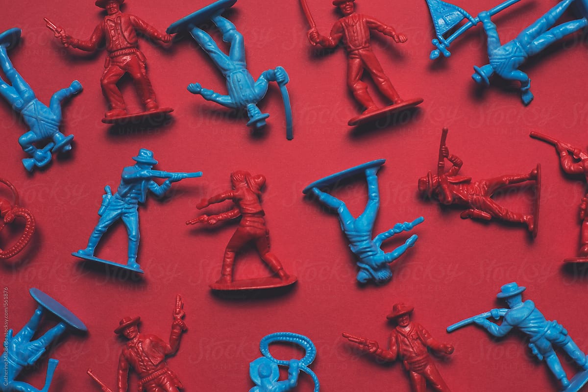 The Battle! red and blue toy cowboys battle it out on a red background