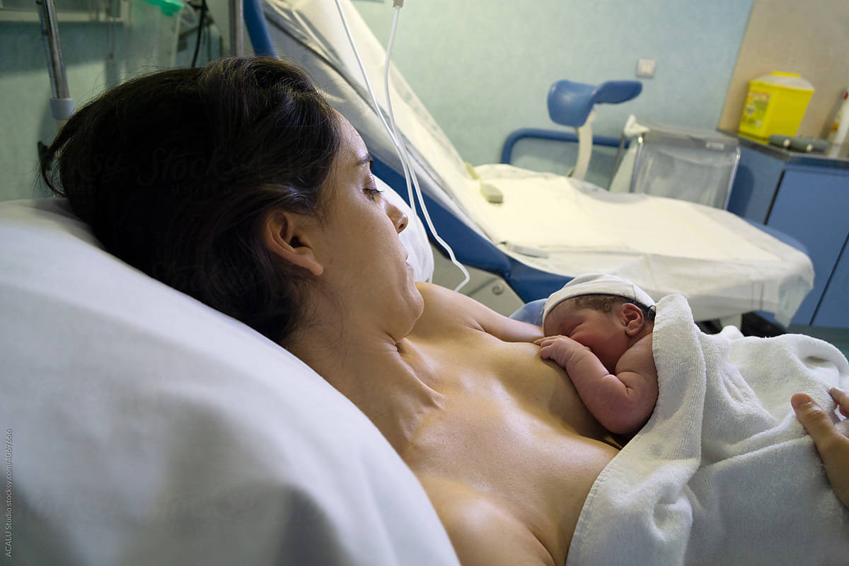 Mother Holding Newborn Baby In Hospital