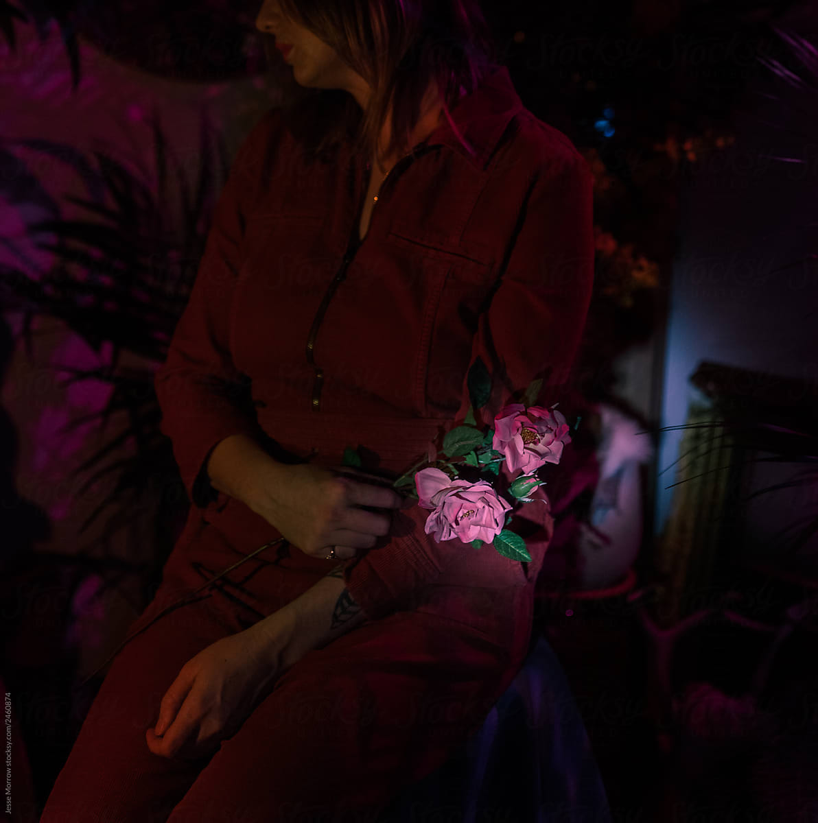 Woman holds flower in lap