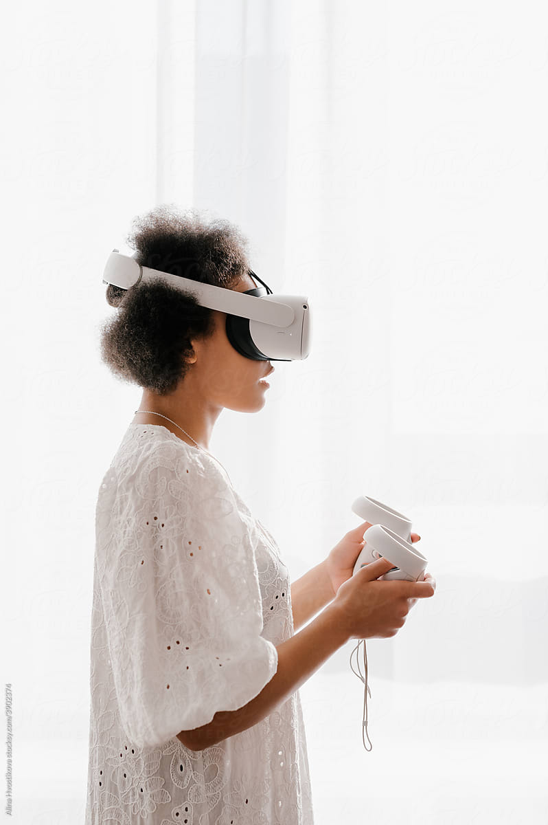 Black woman playing VR videogame