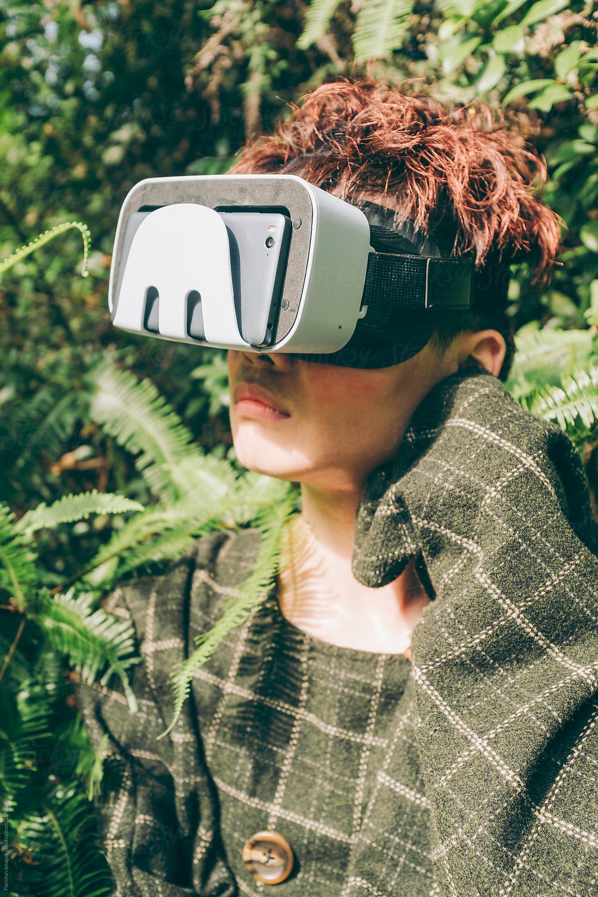 Asian young man wearing a vr headset in forest