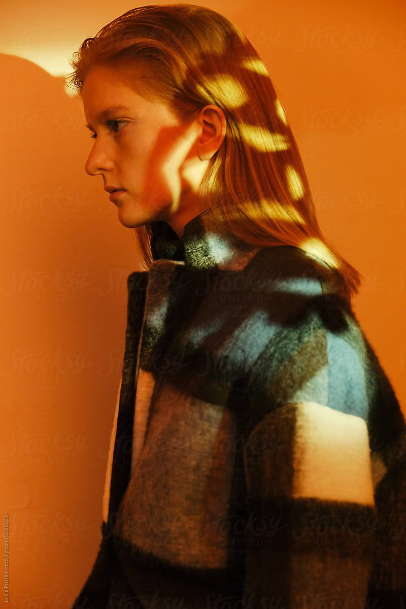 Profile of a young woman with a pattern of light on her hair