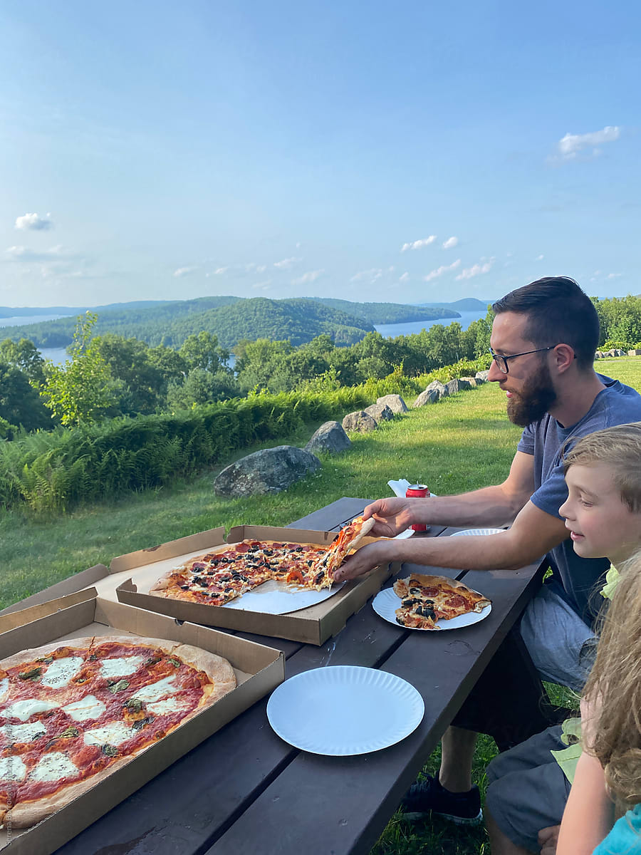 ugc iphone capture of father and children eating pizza with view
