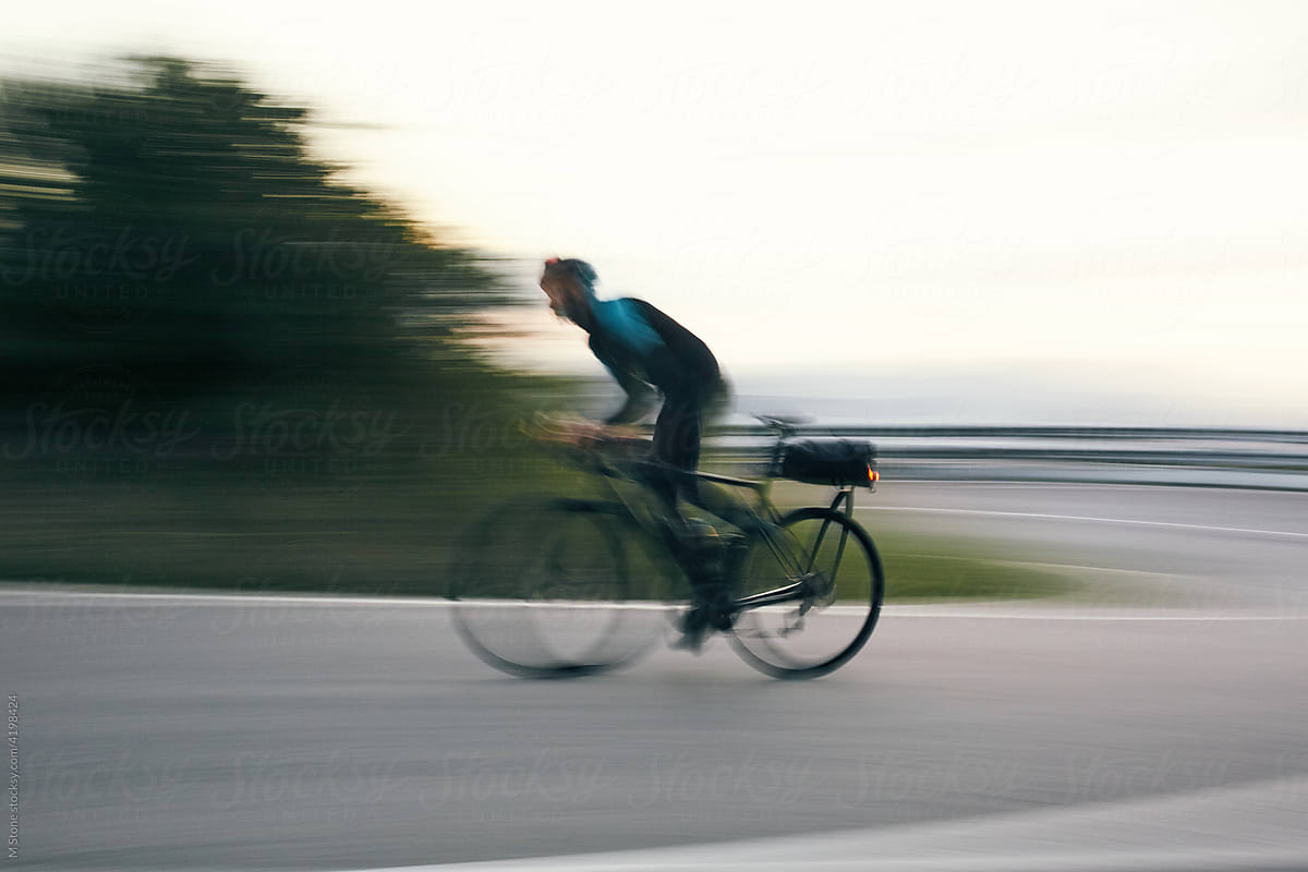 racing cyclist speeds around mountain corner