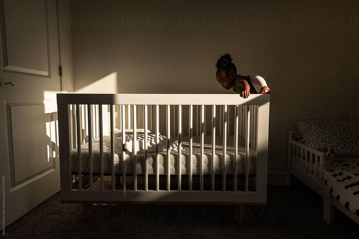 Toddler climbing out a crib