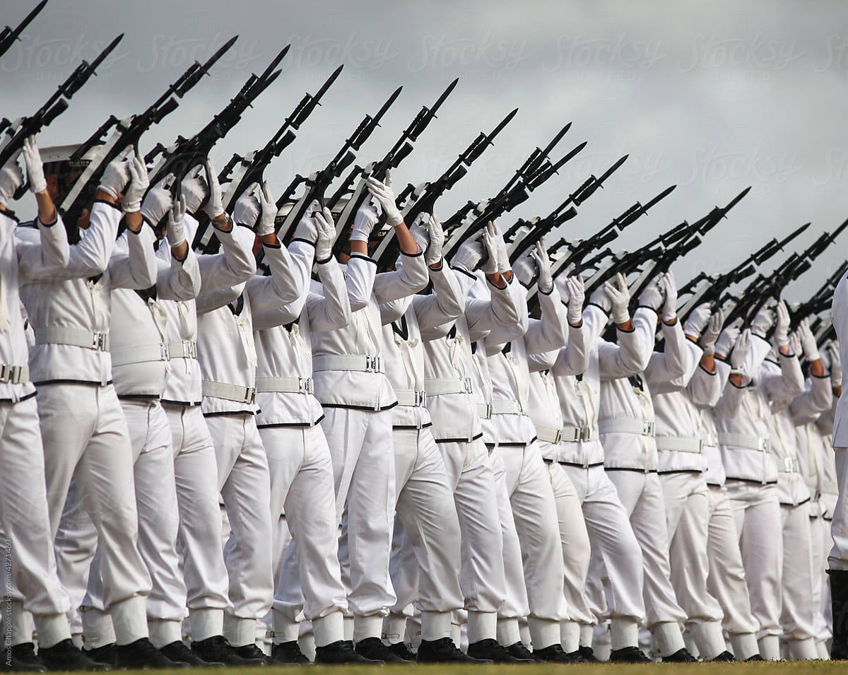 Sailors fire their guns ceremonially