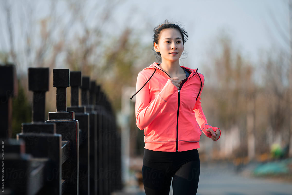 A beautiful Chinese woman running outdoors