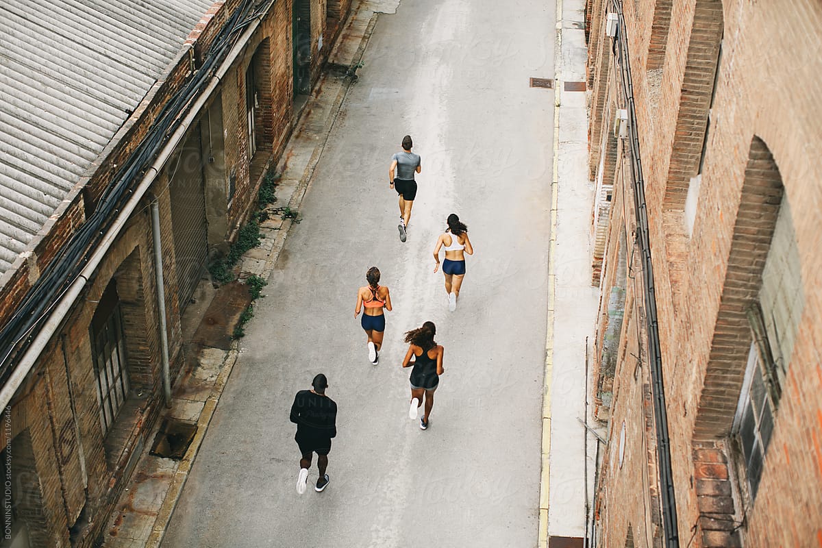 Group of athletes running on the street from above.