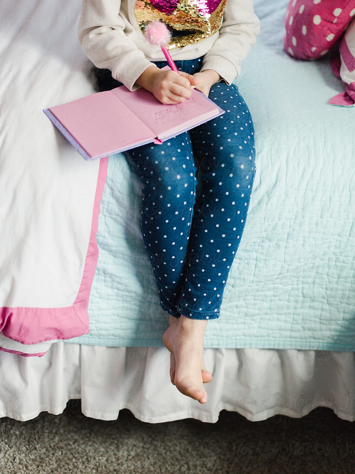 Close Up Of Young Girl Sitting On Bed Writing In Her Diary By Stocksy Contributor Ali Harper 