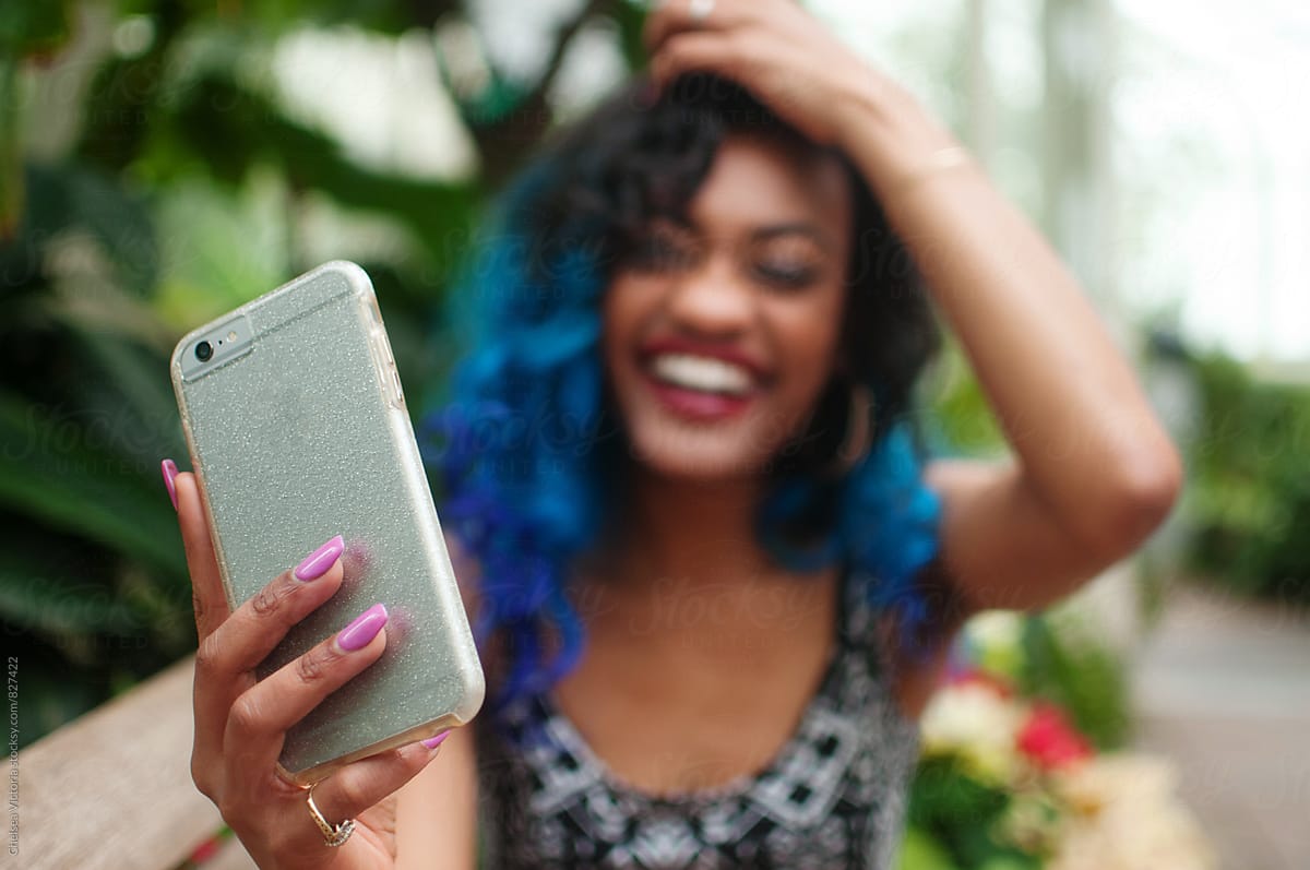 A Young Woman Taking A Self Portrait With A Mobile Cell Phone By