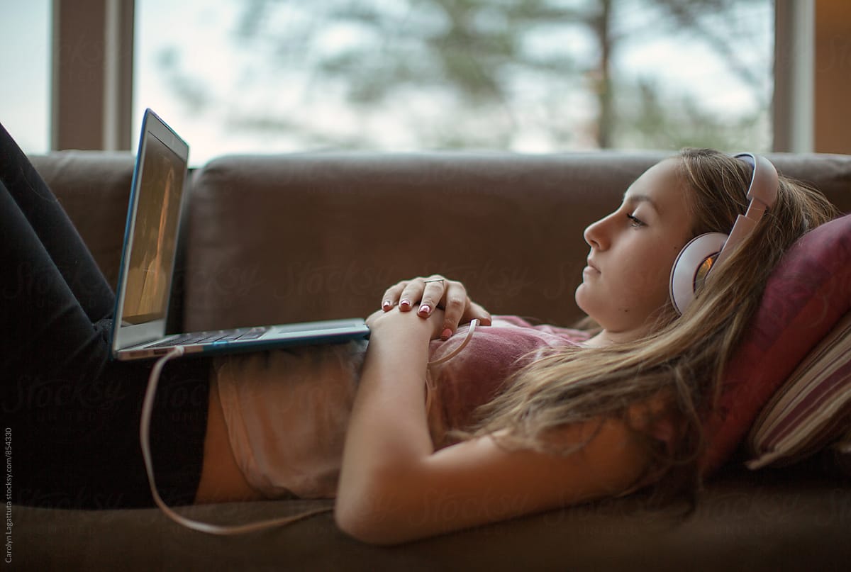 Teenage girl watching TV on her laptop