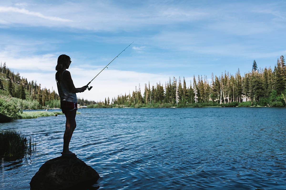 Young Woman Fishing In The Lake by Stocksy Contributor Simone Wave -  Stocksy