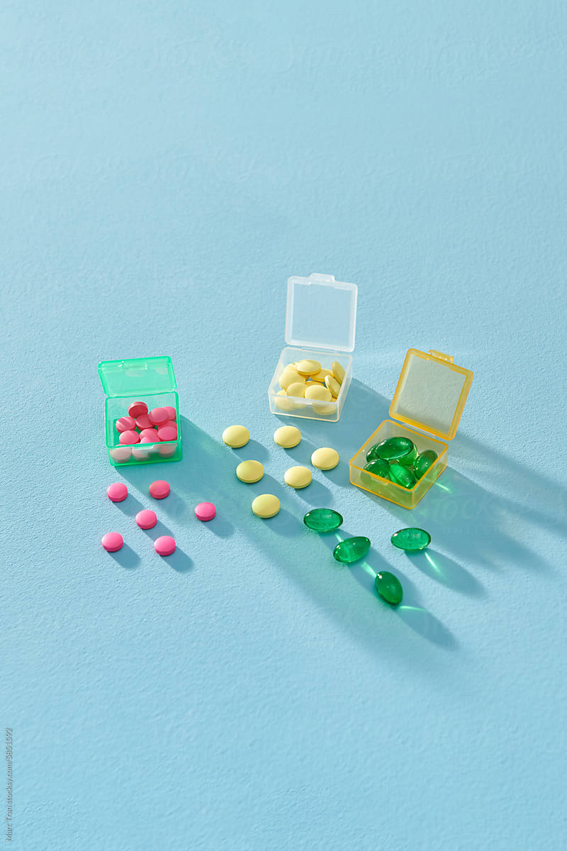 A daily pill box filled with capsules and tablets in different