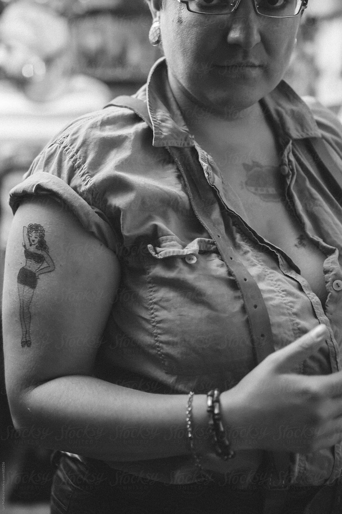 female portrait with a girl tattoo on her arm
