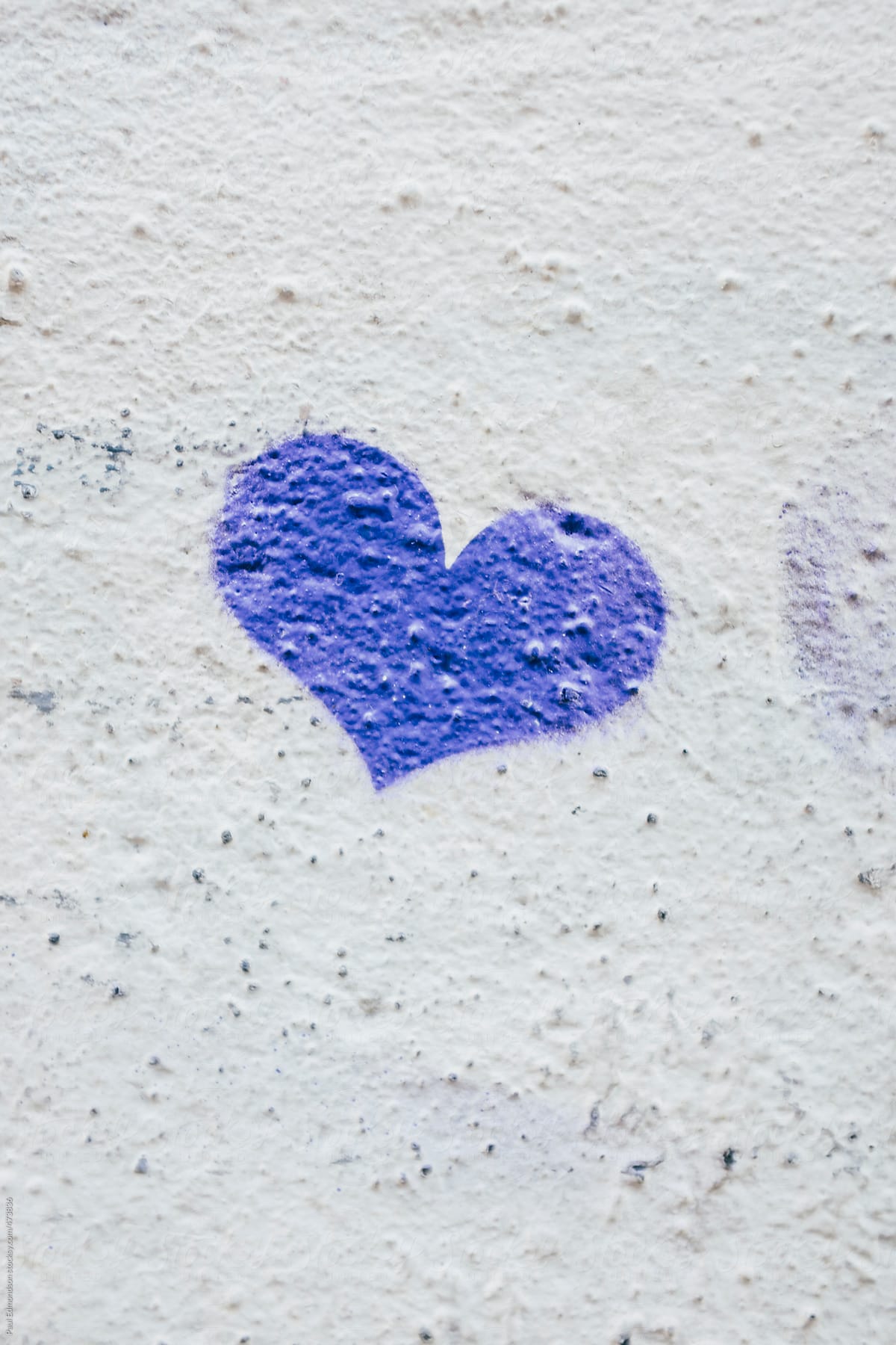 Small heart shape spray painted onto building wall, close up