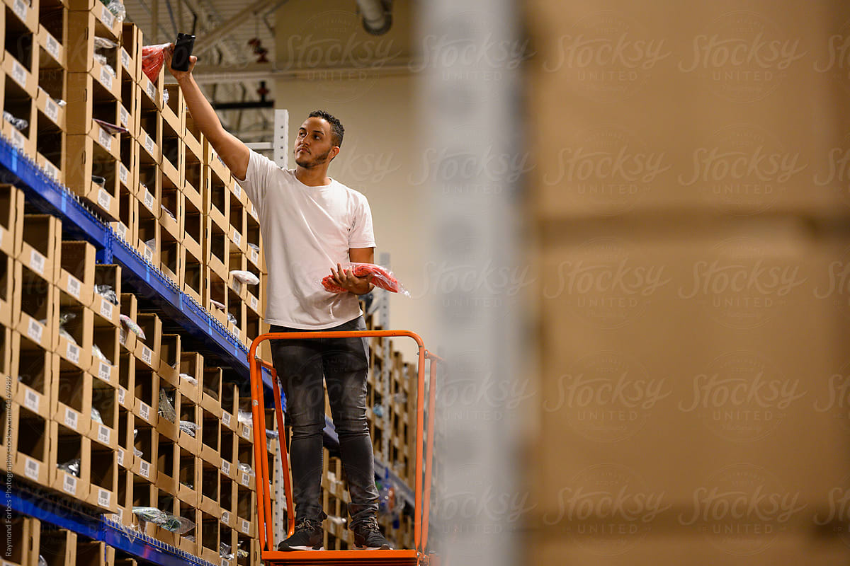 Warehouse picker reaching for product