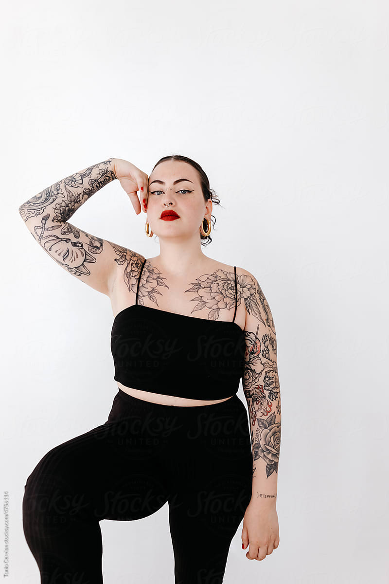 Woman with tattoos and makeup in studio