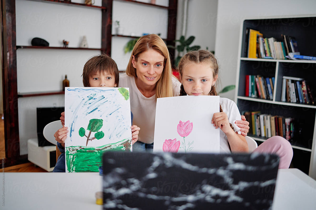 Kids and mother showing painting during online learning