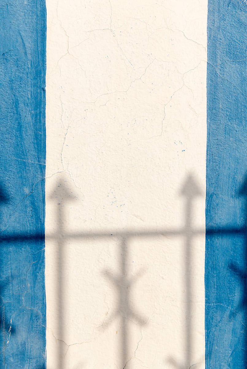White and blue wall in shadow