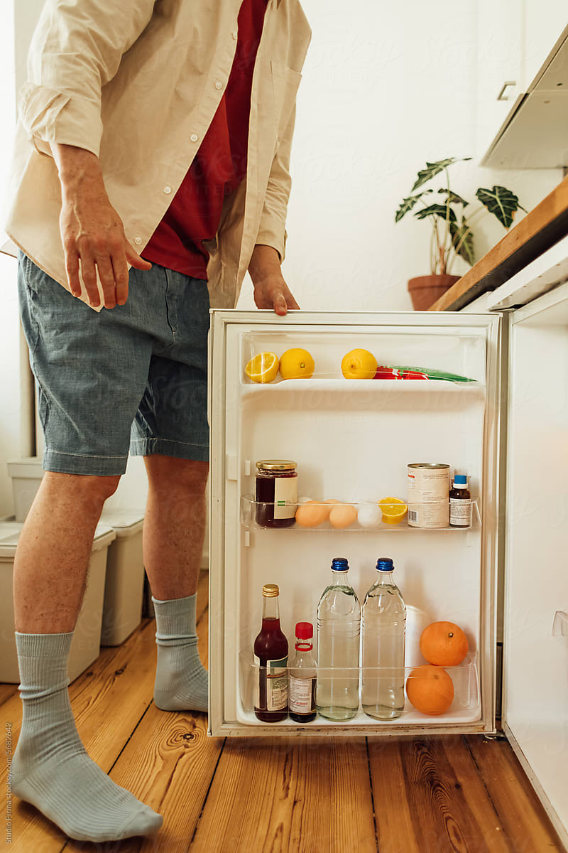 Man opening fridge