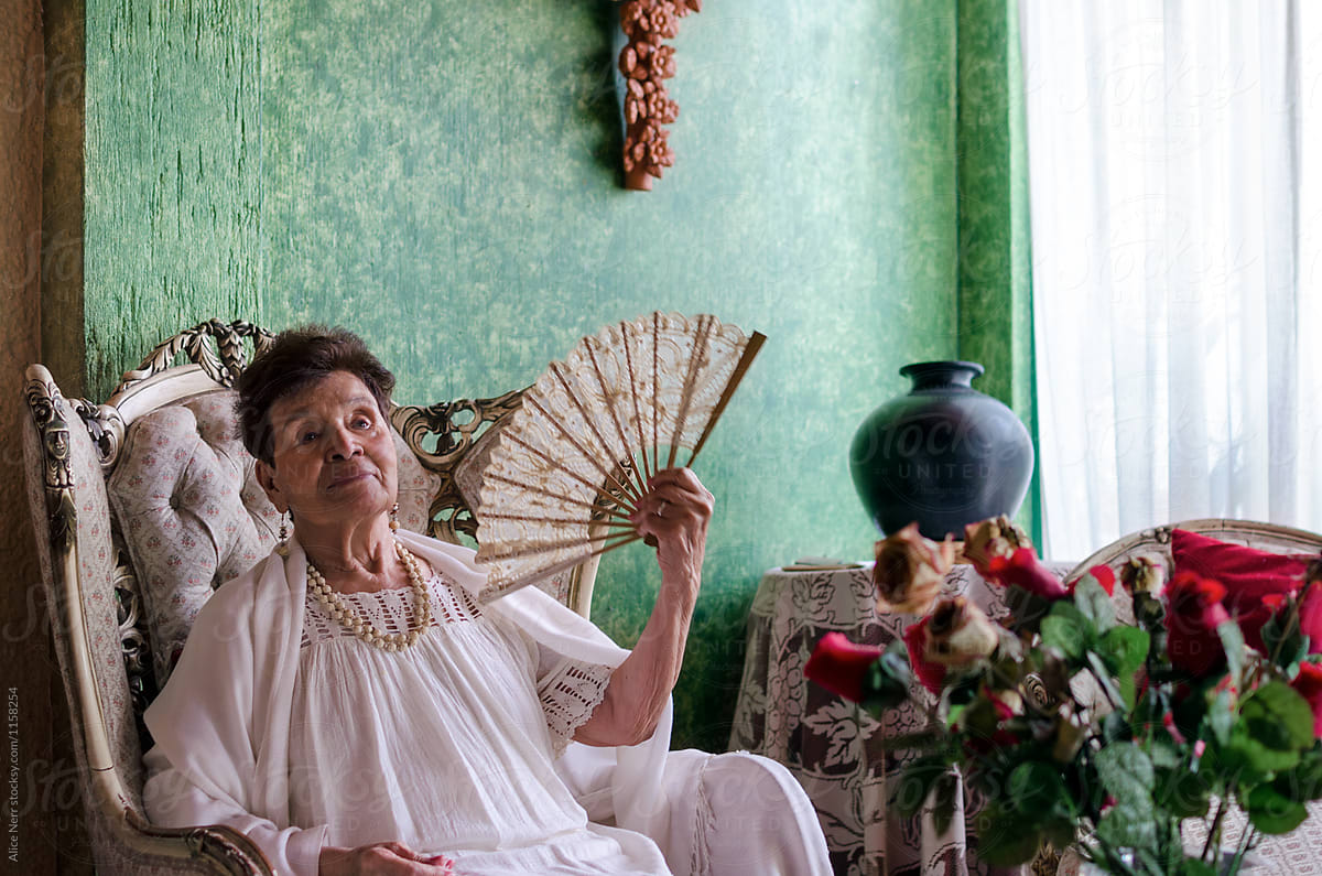 Stylish Mexican Old Lady A Fan In Her Room" by Stocksy Contributor "Alice Nerr" - Stocksy