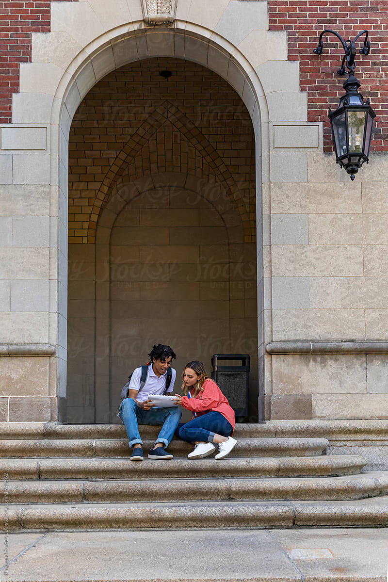 Two cute Friends University Students in brick architecture