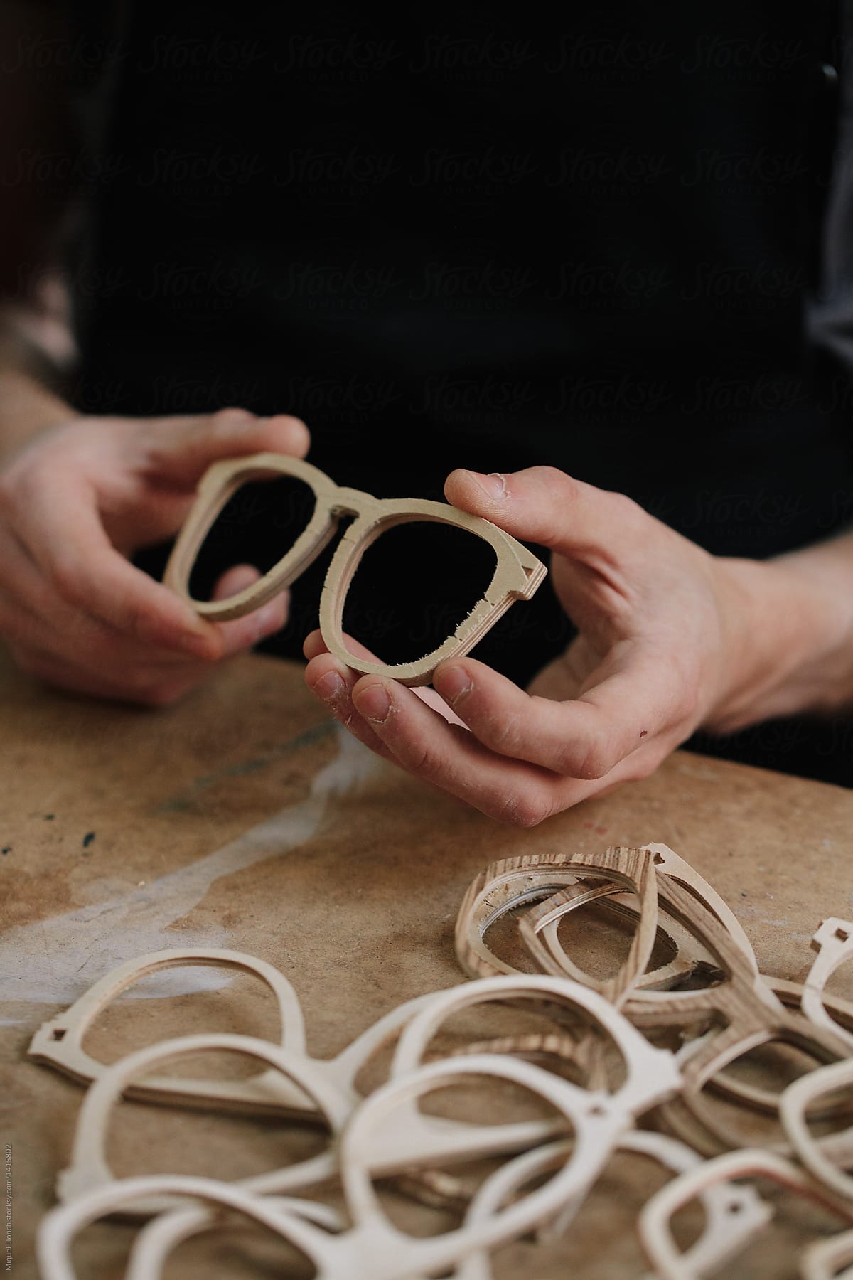 Artisan hands at work with eyeglasses product