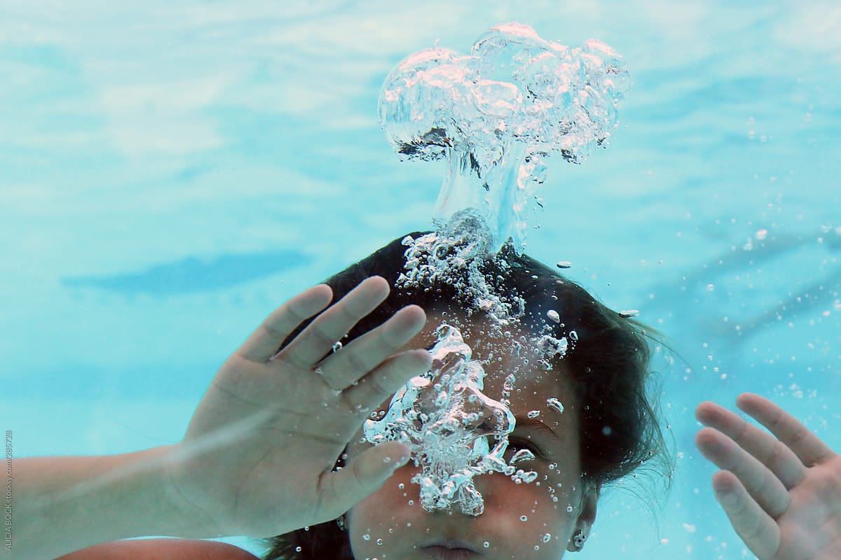 A Girl Holding Her Breath While Swimming Underwater