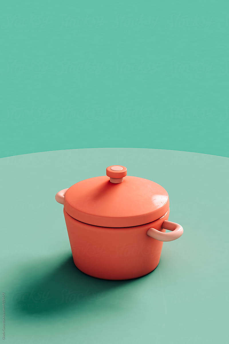 A pink casserole on a green background with copy space