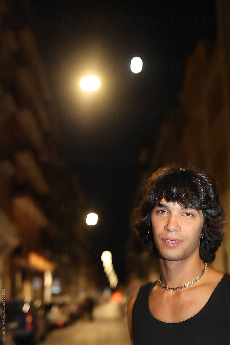 Portrait of young rock musician on the street enjoying nightlife