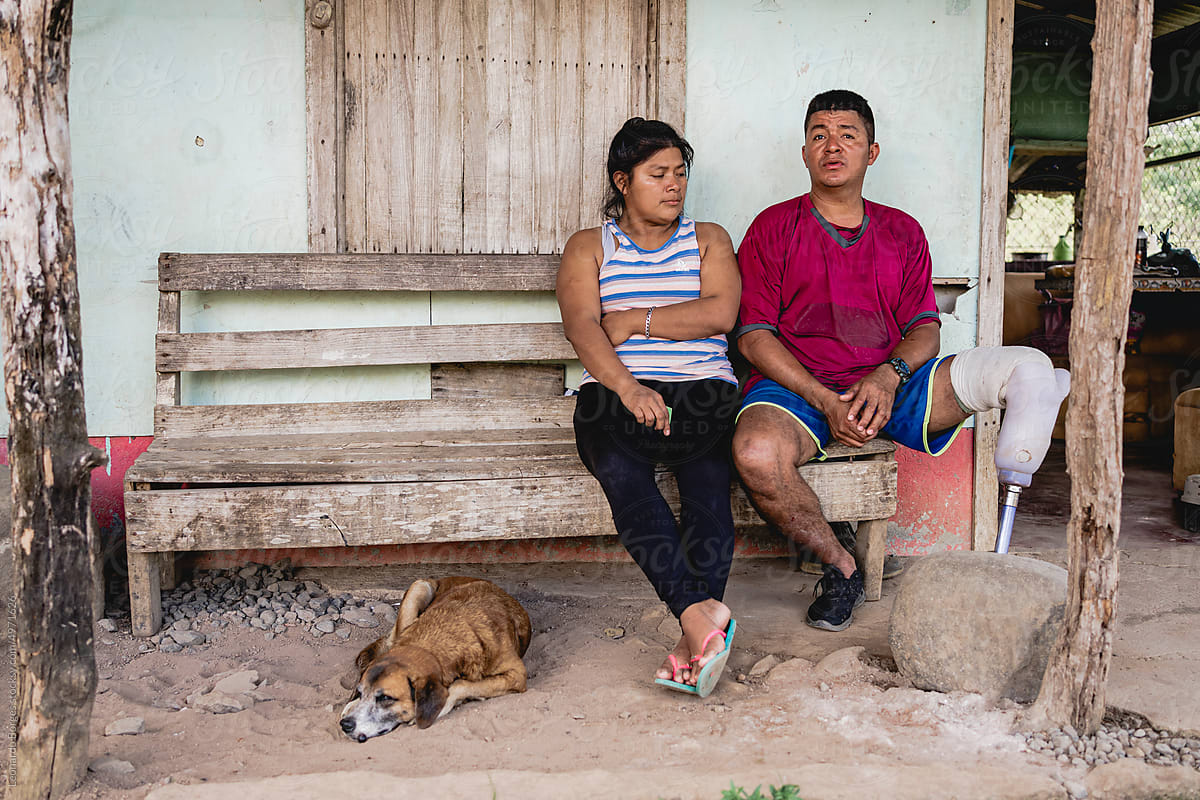 Latin American couple resting in yard in village