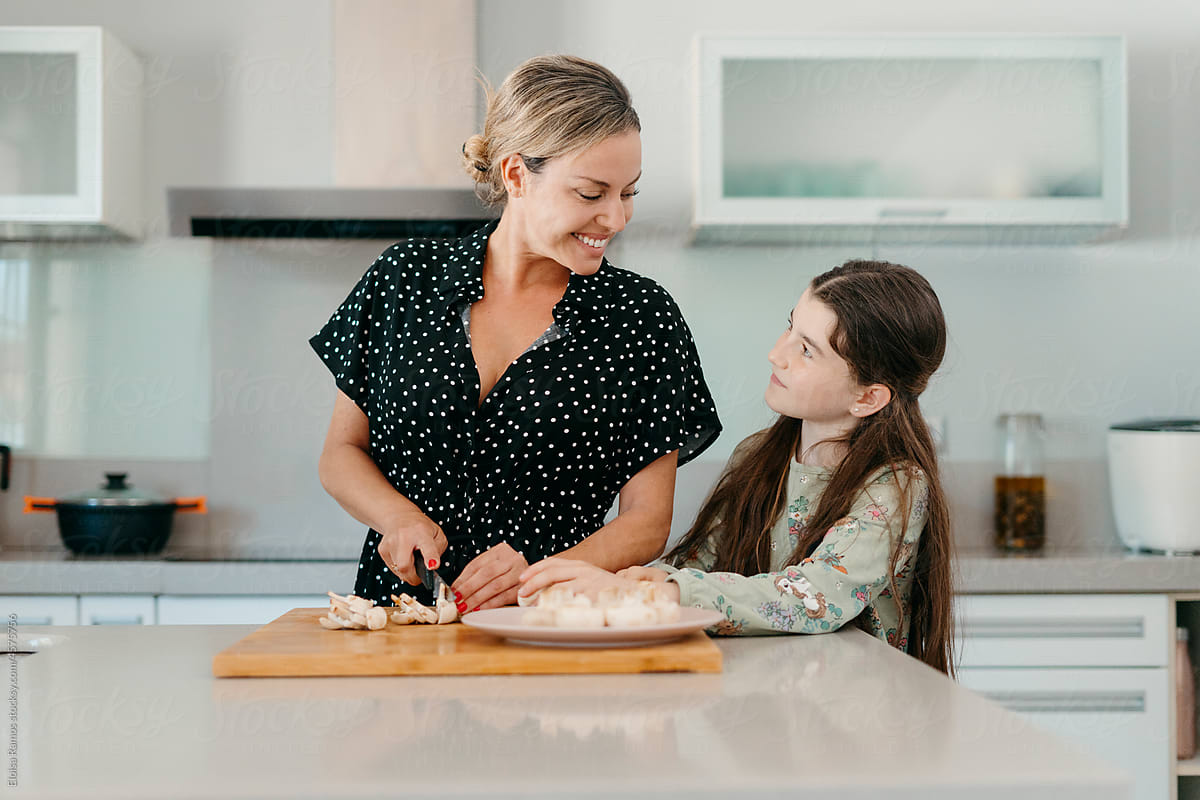 Mother and daughter preparing lunch in kitchen