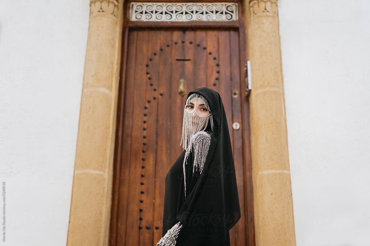 Muslim woman in front of door