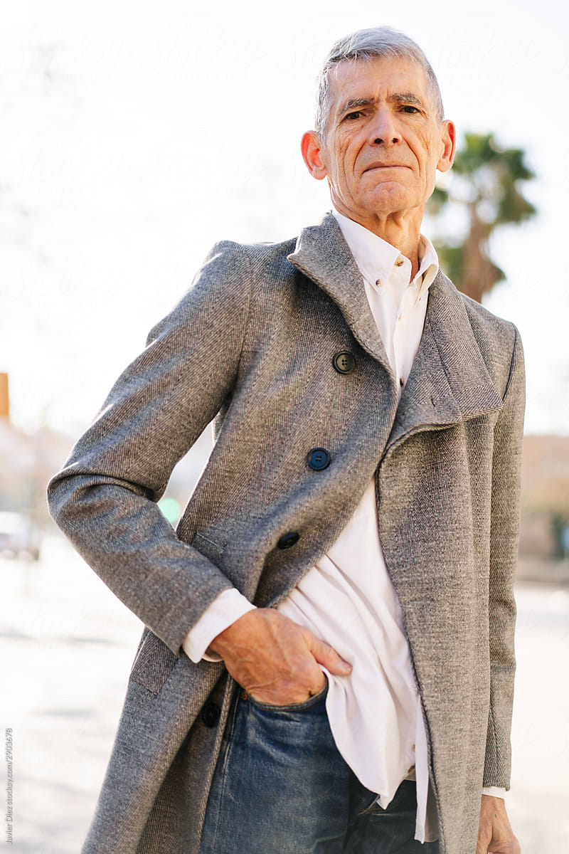 Confident elderly man on street
