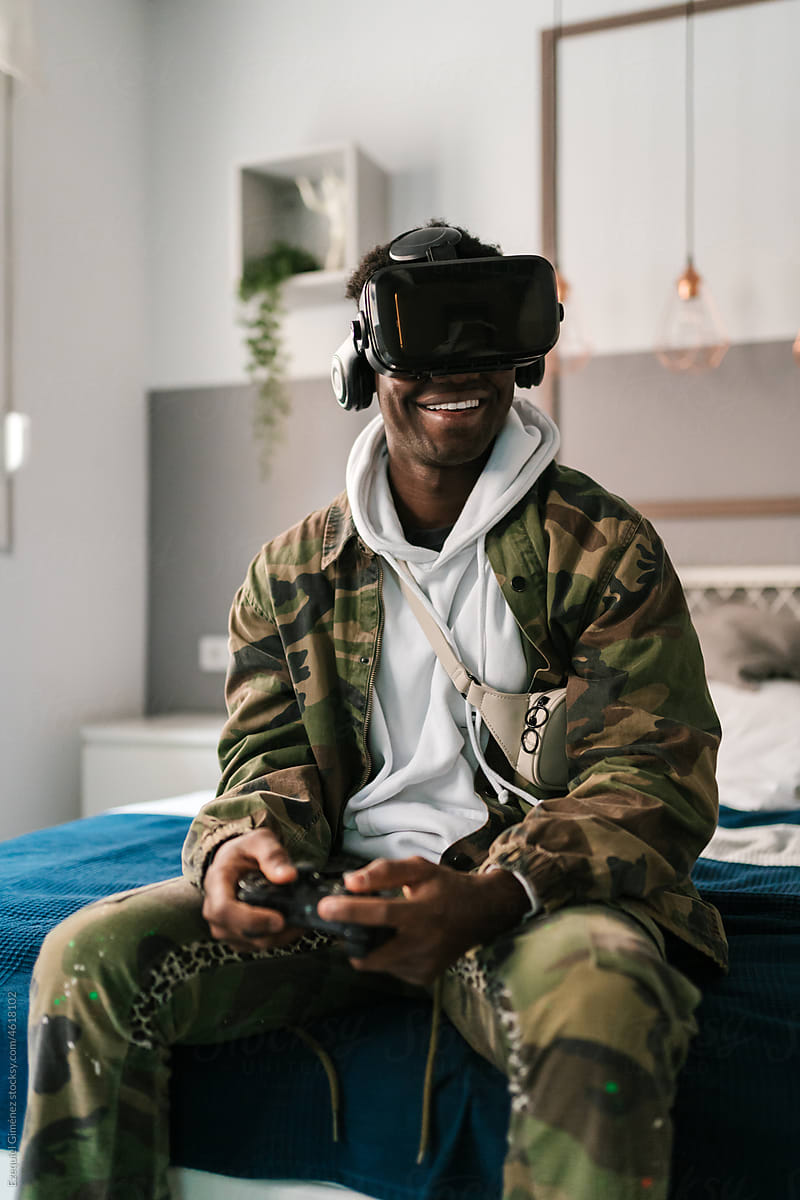 Happy black gamer playing VR videogame