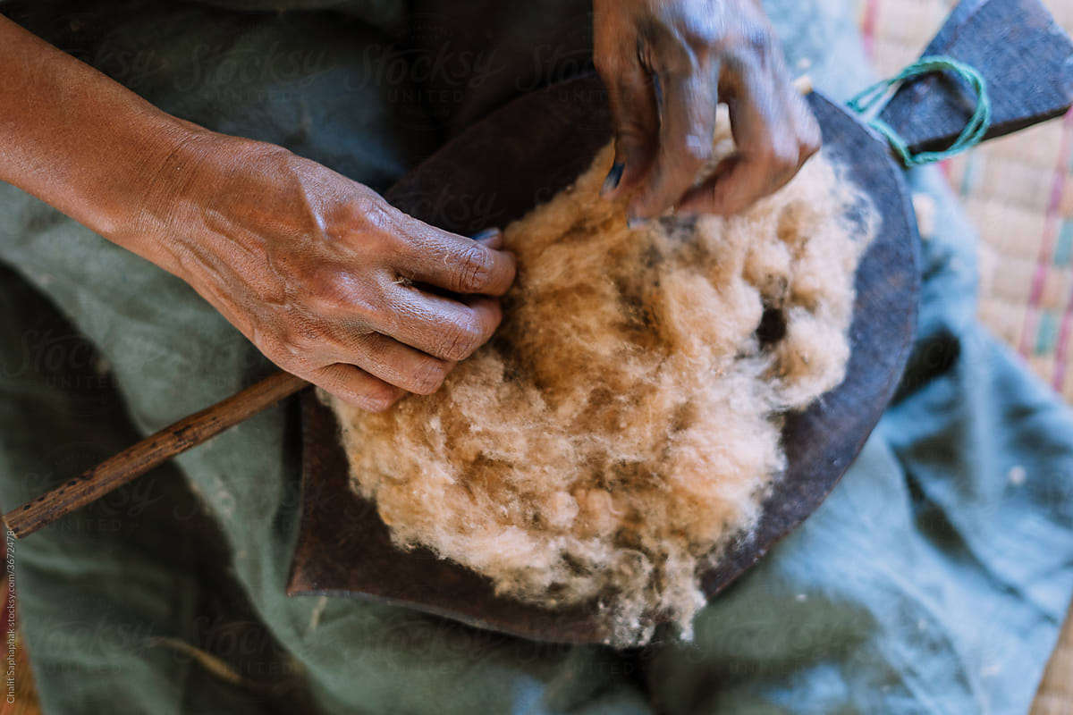 Asian woman roll cotton by hands