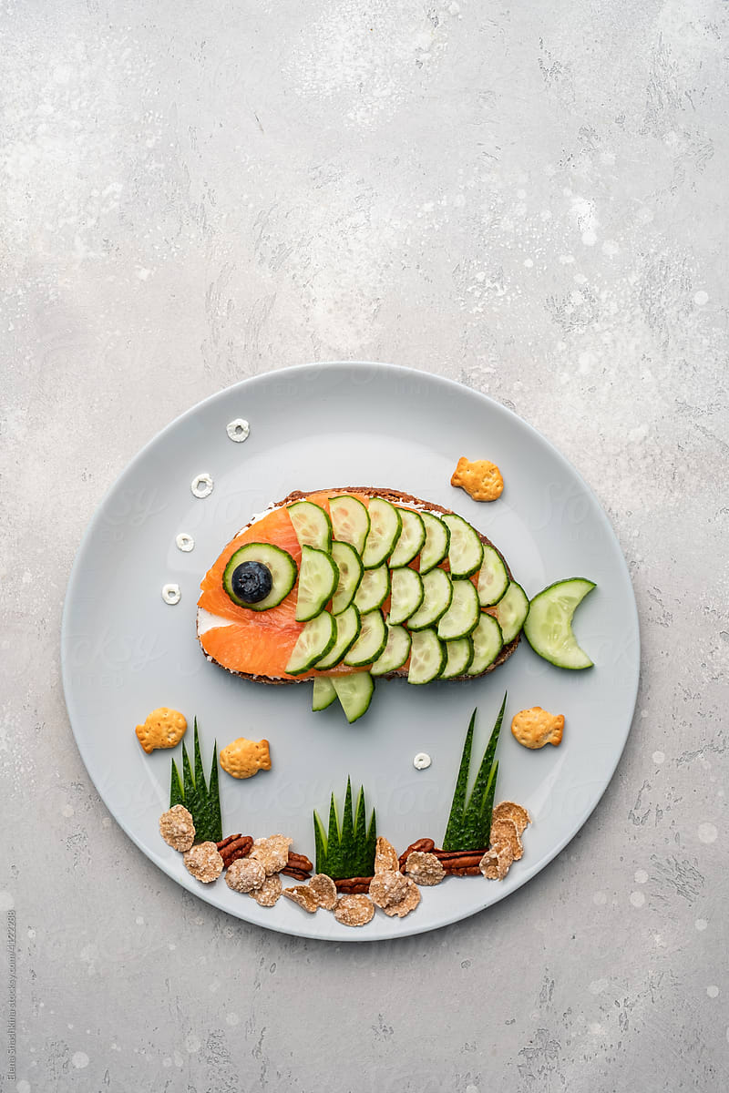Funny salmon fish sandwich with cucumber for kids lunch