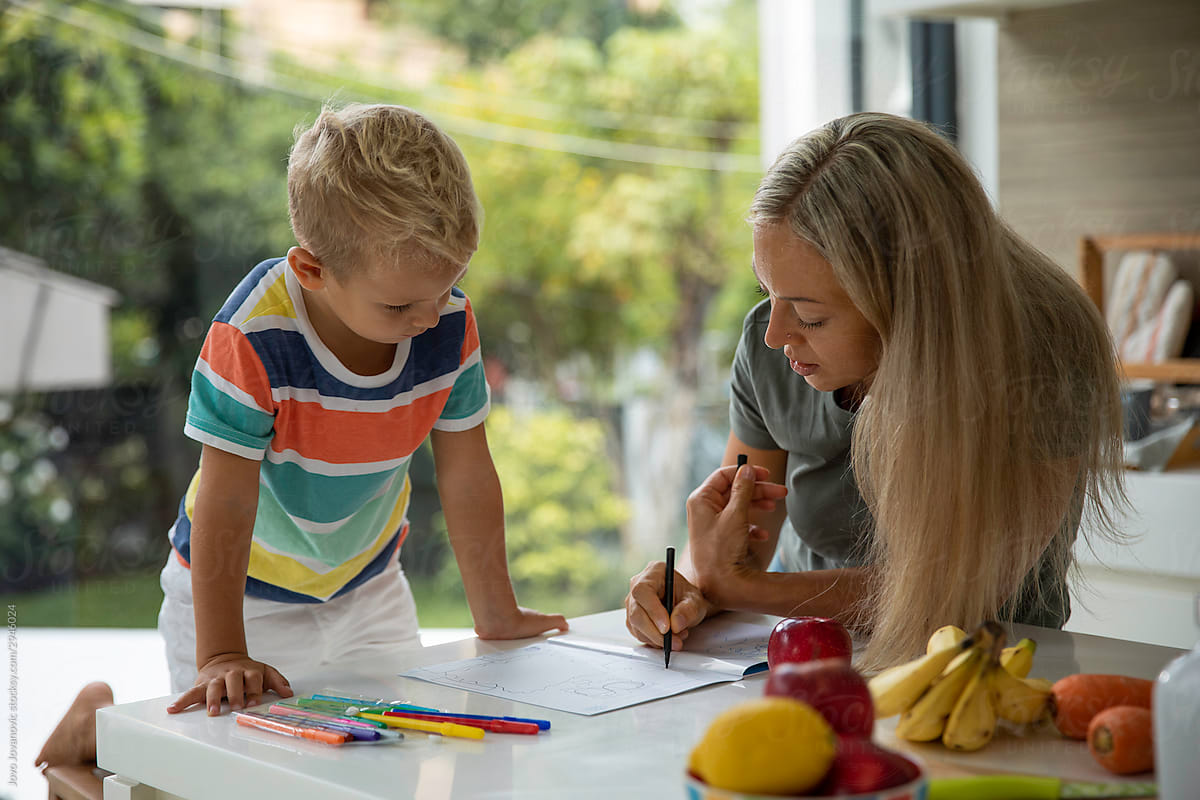 Mother and son drawing together at home