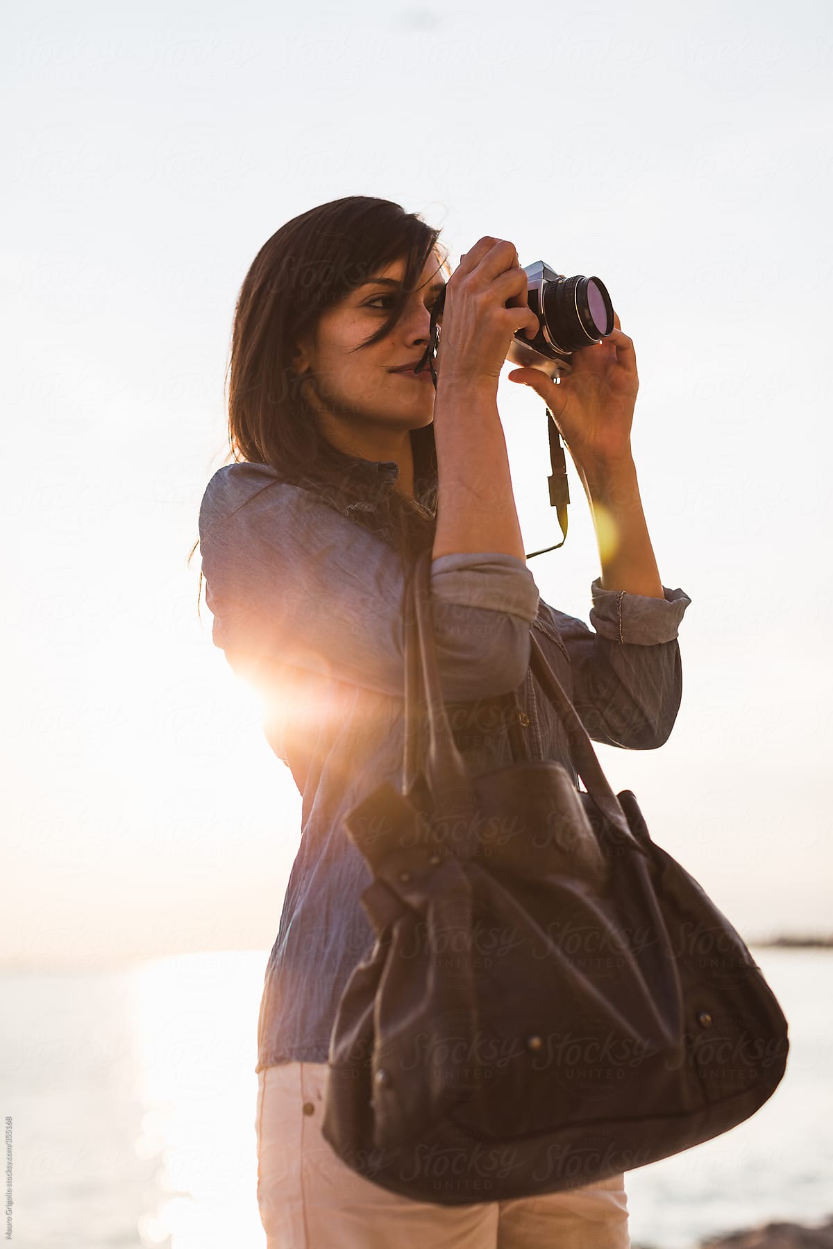 Woman Photographer Taking Pictures At Sunset By Stocksy Contributor Mauro Grigollo Stocksy