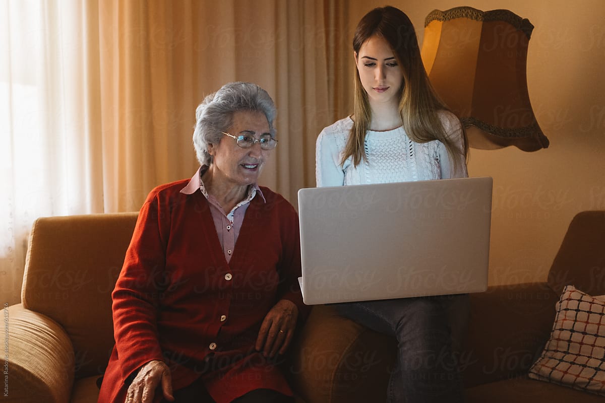 Beautiful Grandma and Granddaughter Using Computer