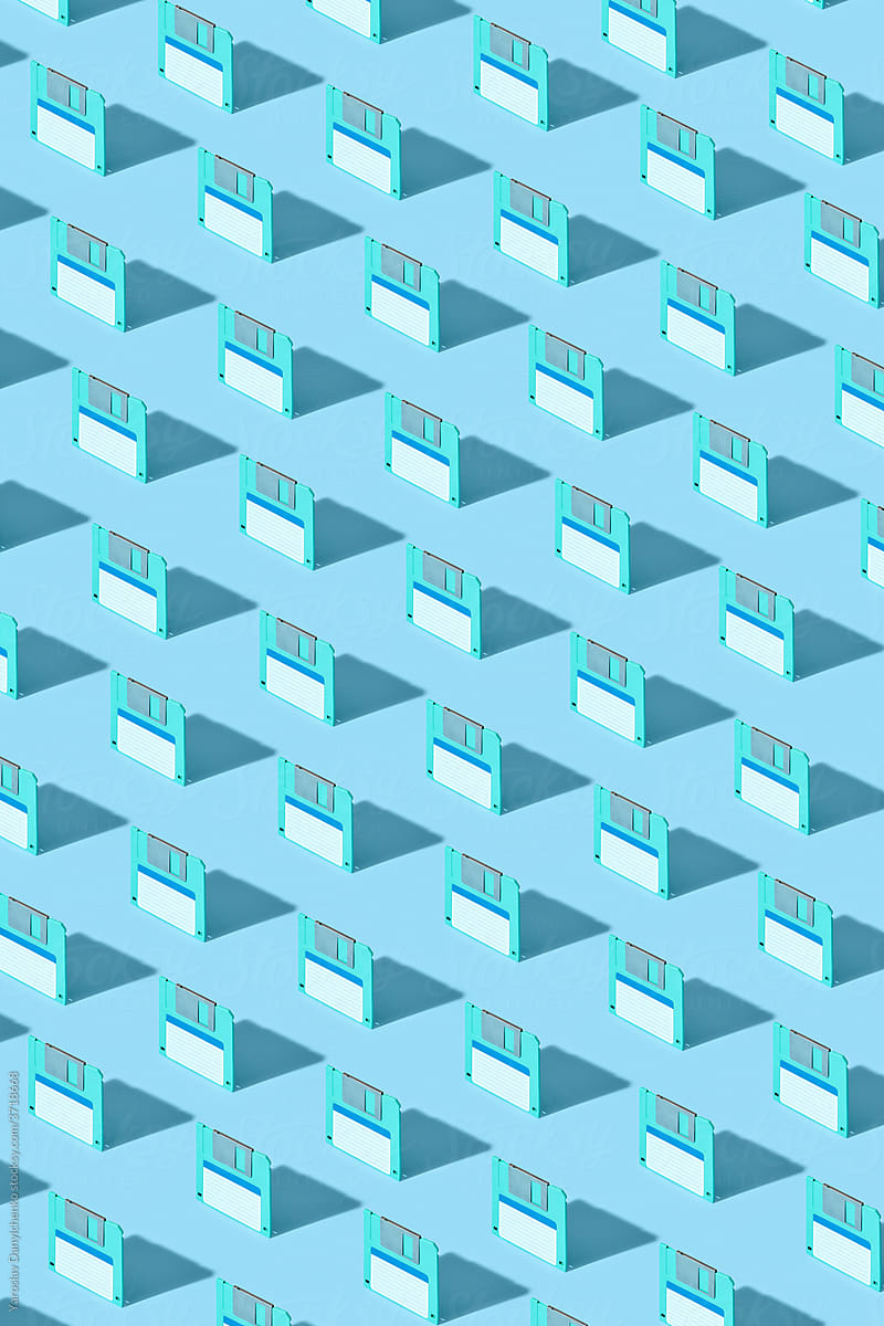 Pattern of green floppy discs on blue background