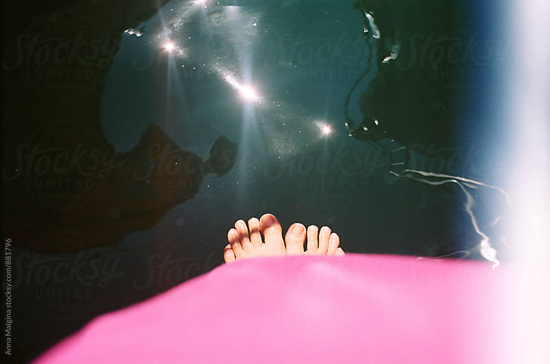 A film photo of girl foot under the water