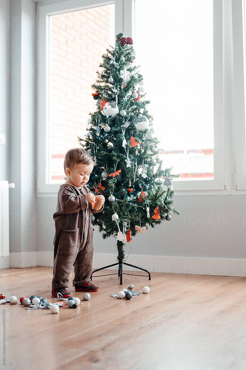 Little boy decorating Christmas tree