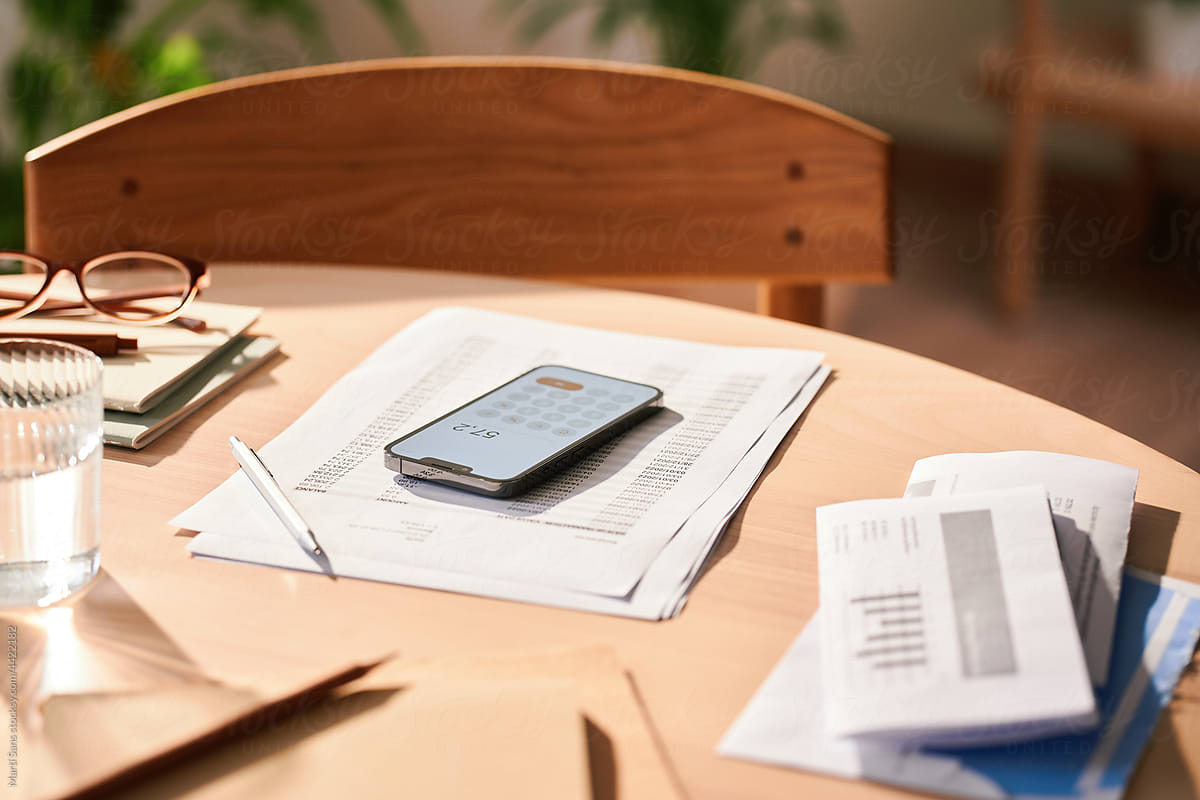 Personal finances with smartphone and invoices