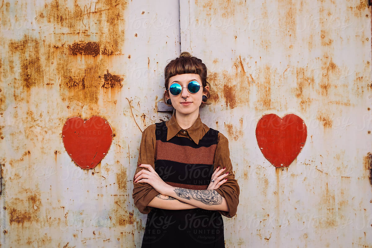 Portrait of Tattooed Woman Between Two Metal Hearts