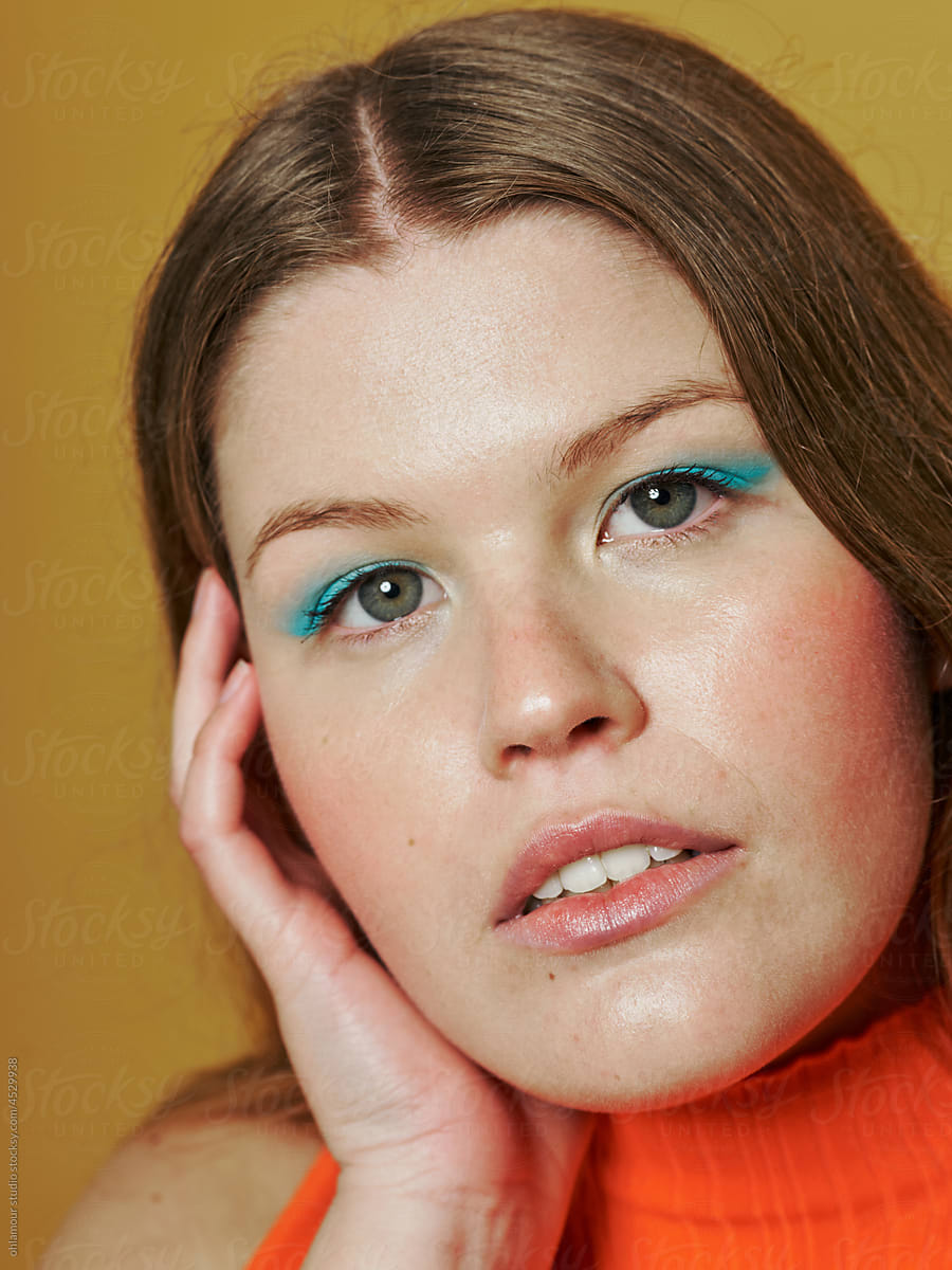 colourful portrait of a confident young woman with colourful makeup