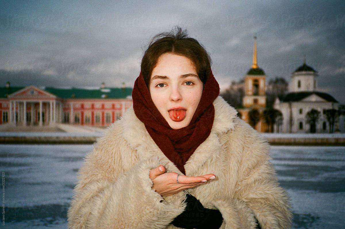 Portrait of a girl with a bleeding tongue in the snow