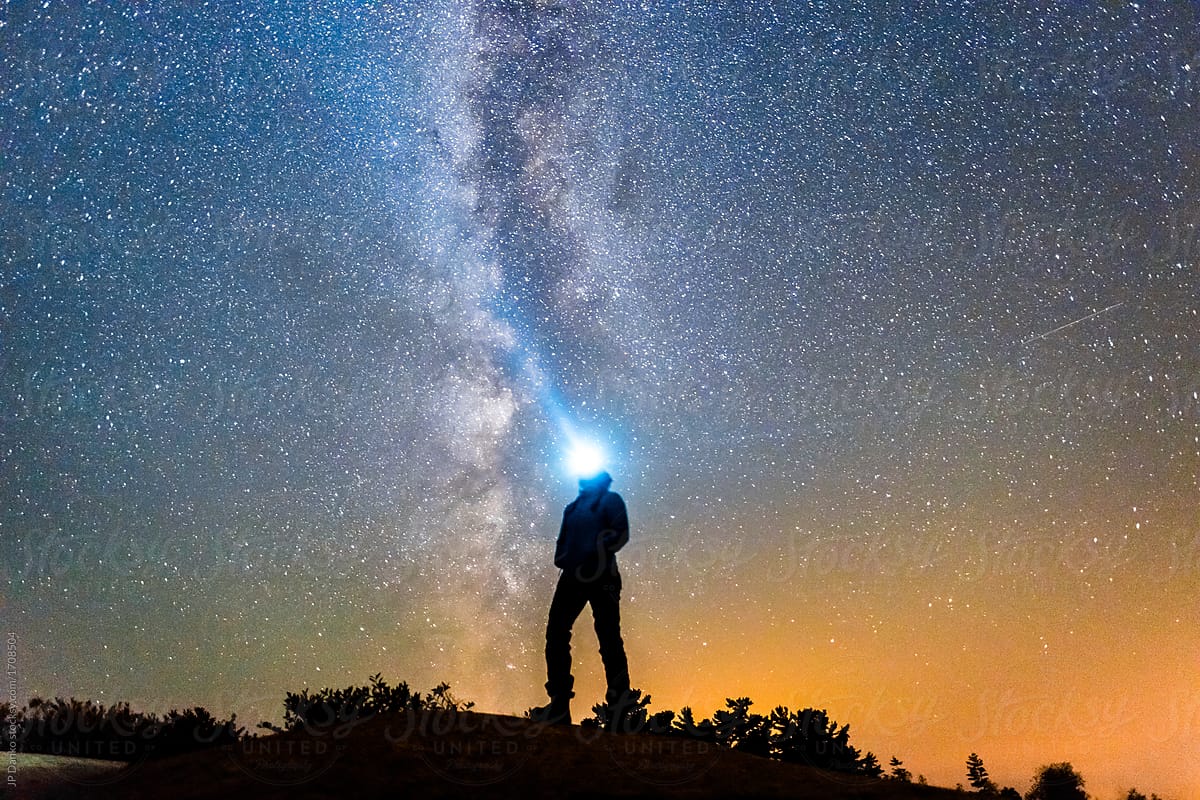 Silhouette of Woman With Headlamp Looking at Milky Way Galaxy Night Sky Stars